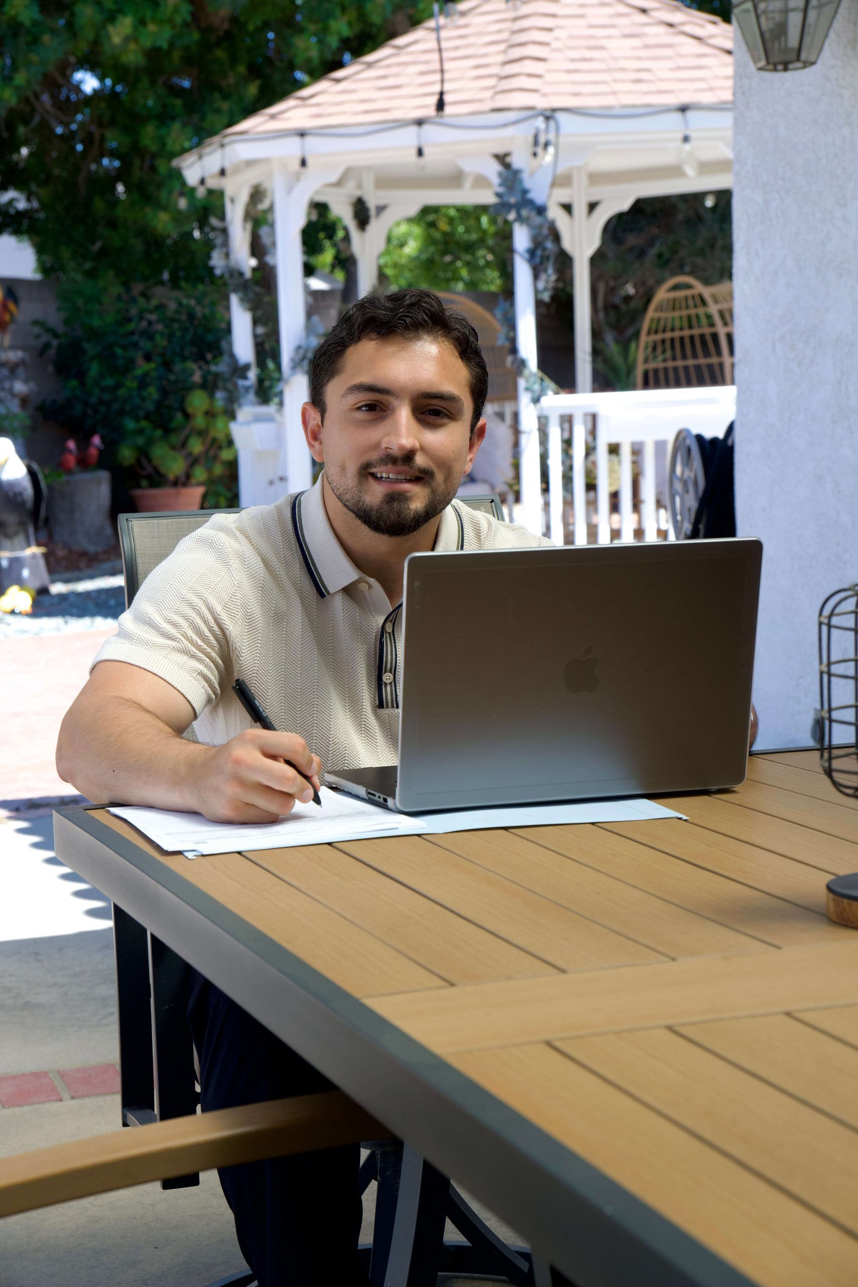 Roberto Valadez at a table under the gazebo
