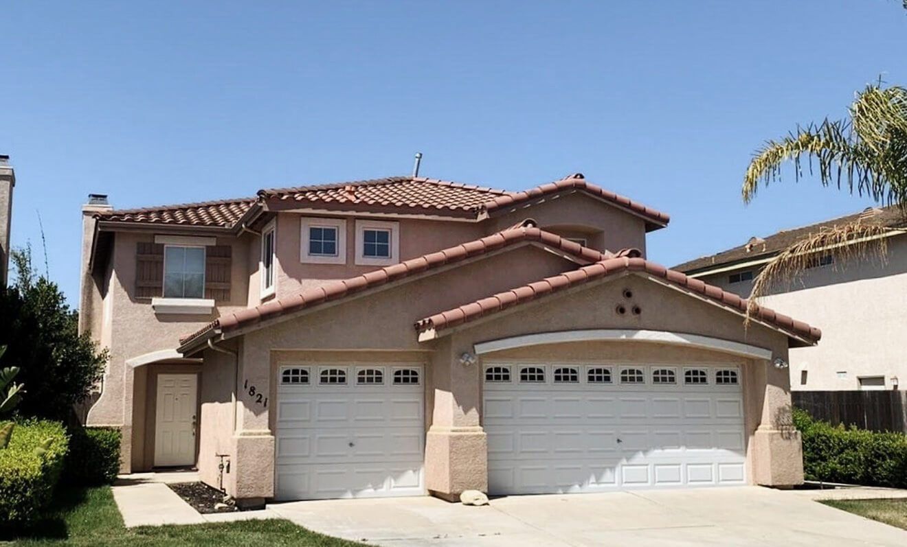 A two-story stucco home with a two-car garage