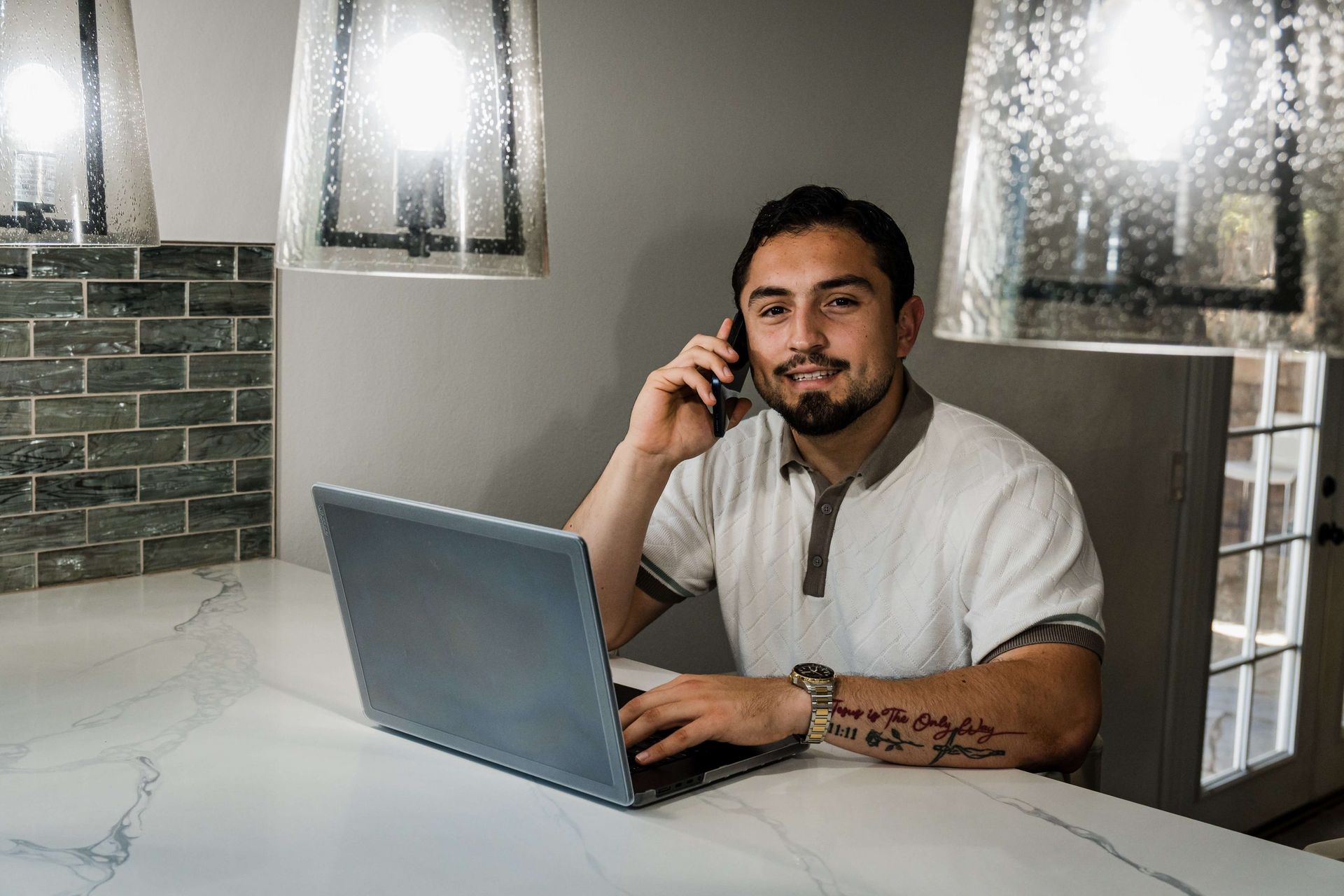 Roberto smiling on a call at the kitchen island